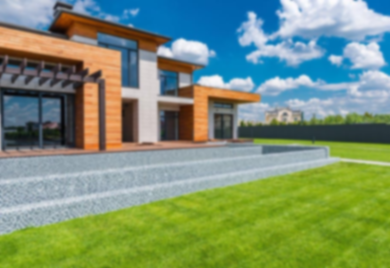 exterior of contemporary residential house with panoramic windows glass doors and green lawn in yard on sunny day against blue sky with white clouds 3